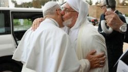 Pope Leo exchanges a kiss of peace with Imam Mohamed Mamoun Al Qasimi at the Great Mosque of Algiers, on April 13, 2026