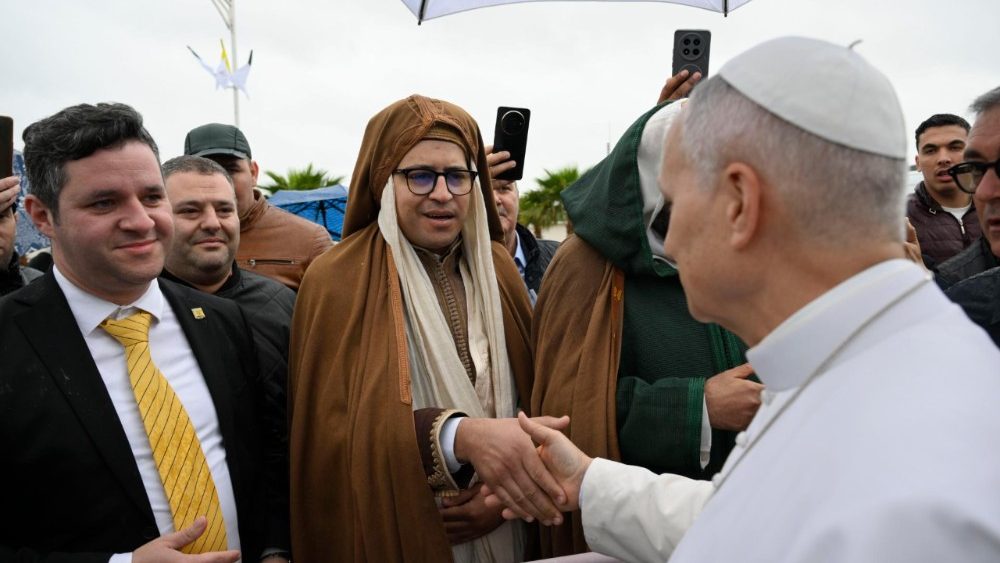 Pope Leo greets people gathered at the archeological site 