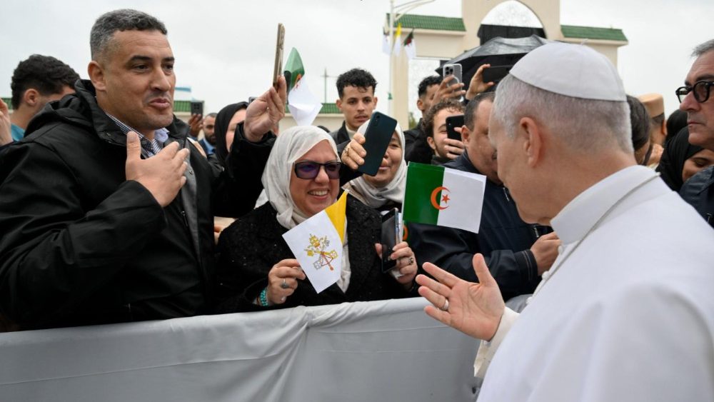 Pope Leo greets people gathered at the archeological site 
