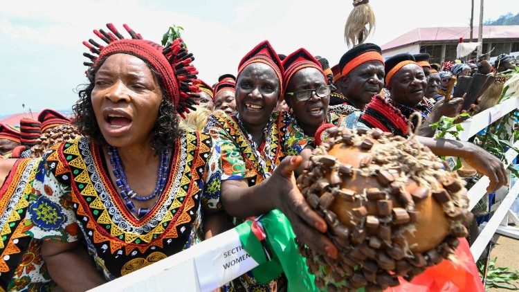 Women in traditional costume wait for the Pope's arrival