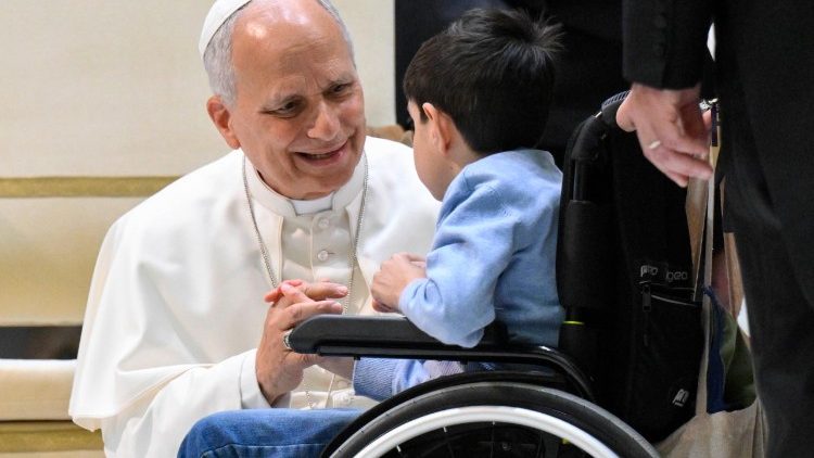 Pope Leo greets a young boy