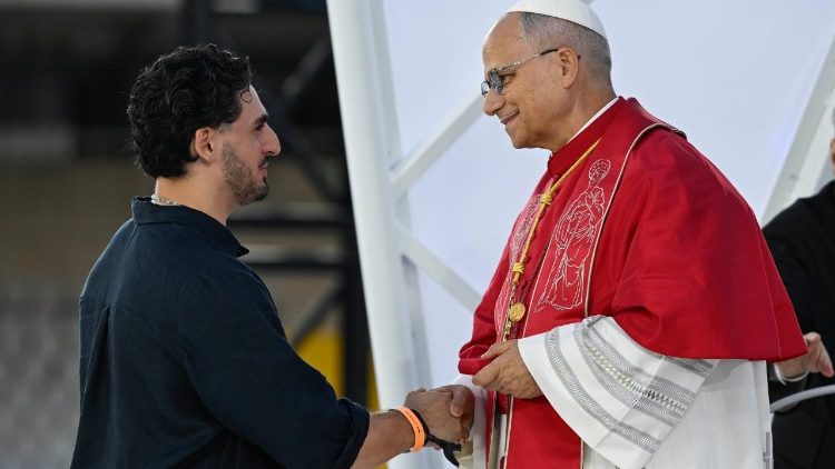 Pope Leo shakes hands with the recently baptised man who gave his testimony
