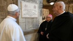 Pope Leo looks at a plaque outside the Basilica, commemorating his visit there 