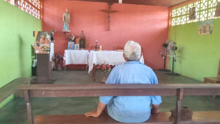An elderly man praying in the farming community of San Jose