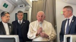 File photo of Pope Francis greeting journalists aboard papal flight