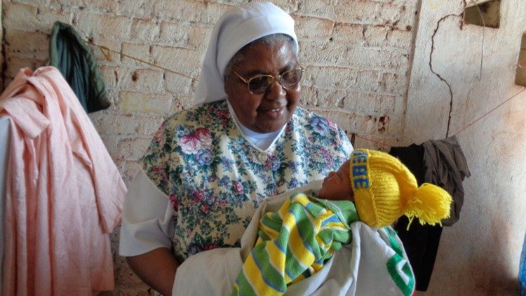 Sr Alphonsa holding a baby born the day after she arrived