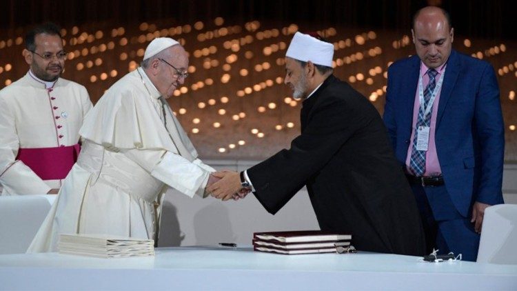 Pope Francis and Grand Imam of Al-Azhar, Ahmed Al Tayeb, shaking hands at the signing of the document on "Human Fraternity for World Peace and Living Together" in 2019