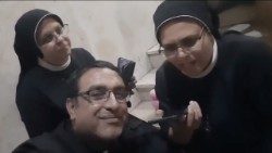 Sister Saleh (R) and Fr. Yusuf speak with Pope Francis by phone