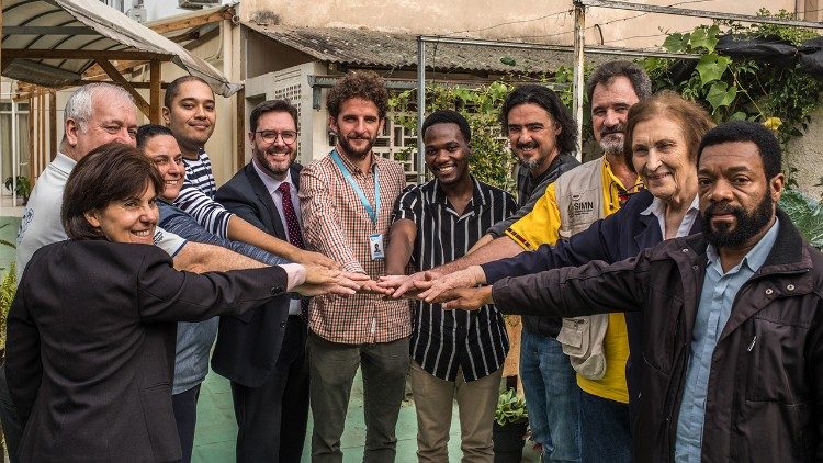 Narrador Kanhanga (in the middle, with the black and grey striped shirt) left Angola 18 years ago and settled in Brazil. Today he works closely with other experts to best respond to the challenges faced by migrants. (Giovanni Culmone/Global Solidarity Fund)