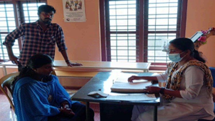 Sister Joicy, right, meeting with clients