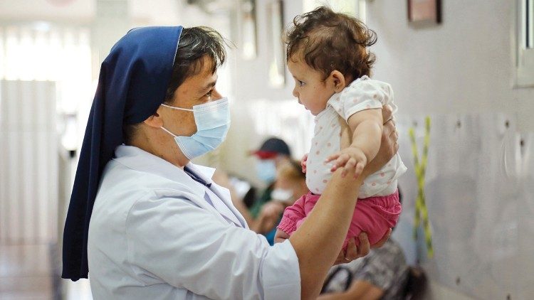 Good Shepherd Sister Antoinette Assaf assesses a child at St. Anthony Community Health Center in Roueissat, Lebanon. Photo: