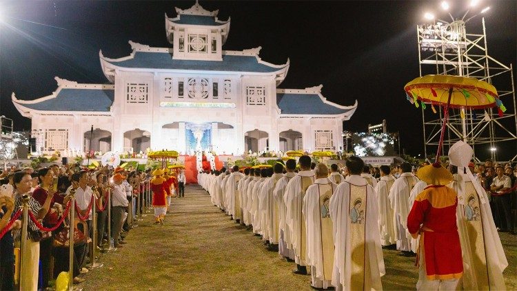 Clergy and faithful process toward the Basilica altar during the Assumption feast at the shrine of Our Lady of La Vang. Photo: