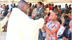 Young people receive the Eucharist during Mass at the VIWAWA congress