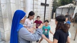 A religious sister works with young people inside the Holy Family parish compound