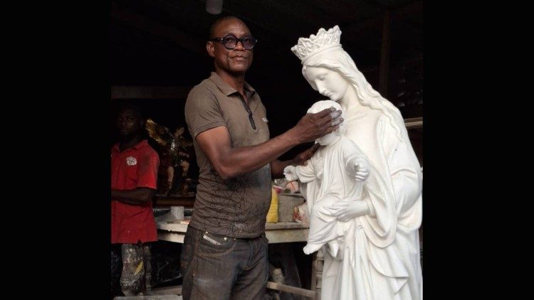 Armand Touboui, travaillant sur une statue de la Vierge Marie