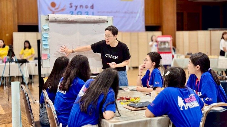 Pitching Coach Ple Voranunt guides a team of student hackers through brainstorming and prototyping during MISSION POSSIBLE Youth Social Hackathon Season 2 in Thailand, July 2025.
