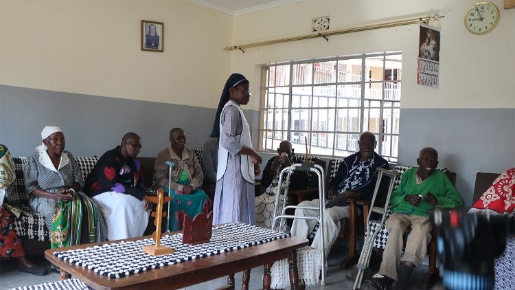 A Benedictine sister addresses elderly residents at St. Catherine's home for the Aged, a moment of care and presence