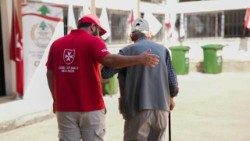 An Order of Malta Lebanon worker assists an elderly person (Lebanese Association of the Knights of Malta (Order of Malta Lebanon))