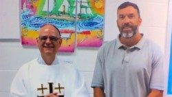 Archbishop Mark Rivituso, then auxiliary bishop of St. Louis, meets with Lance Shockley in the Potosi Correctional Center in Missouri