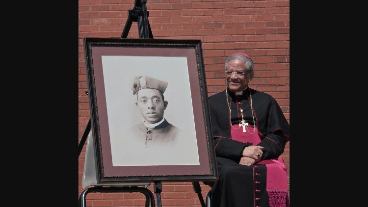 Bishop Jospeh Perry, diocesan postulator of Father Tolton's cause, near his portrait