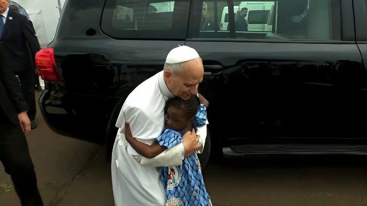 Leone XIV abbraccia una bambina durante una Messa in Camerun