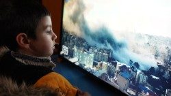 Jason, 5, watches the Israeli bombardment of Dahye, a southern suburb of Beirut, live on television. He and his family fled nearby Hadath and found shelter with the Antonine Sisters.