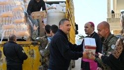 Archbishop Paolo Borgia helping to distribute aid